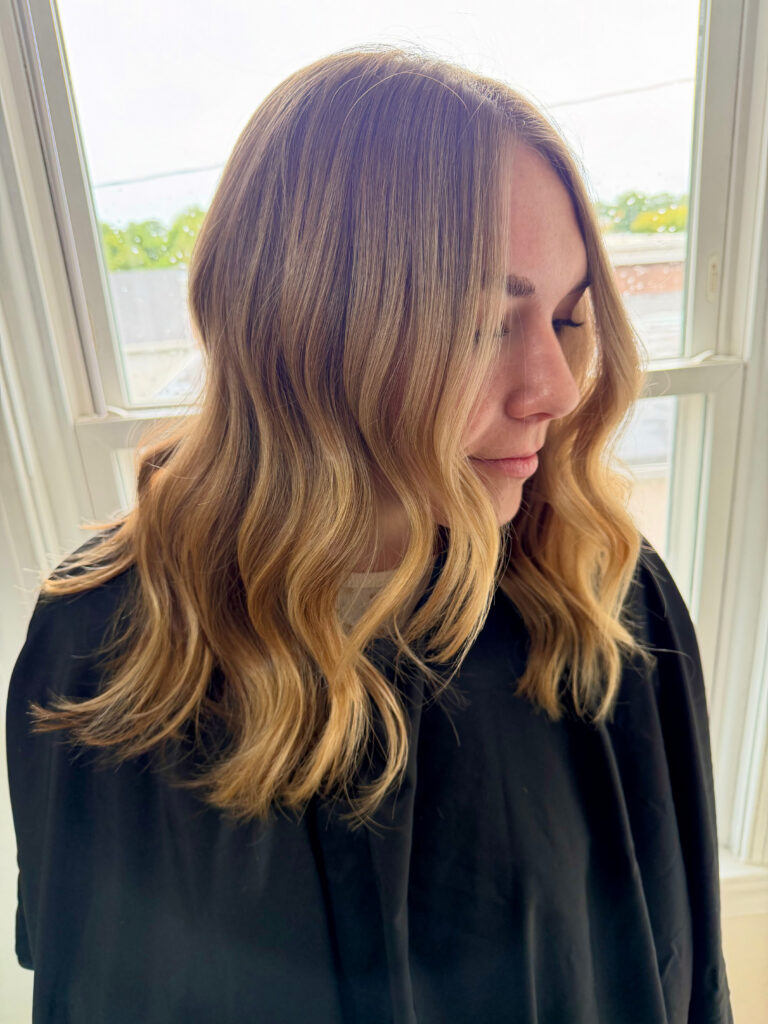 Golden balayage with soft waves, finished at BR Collective