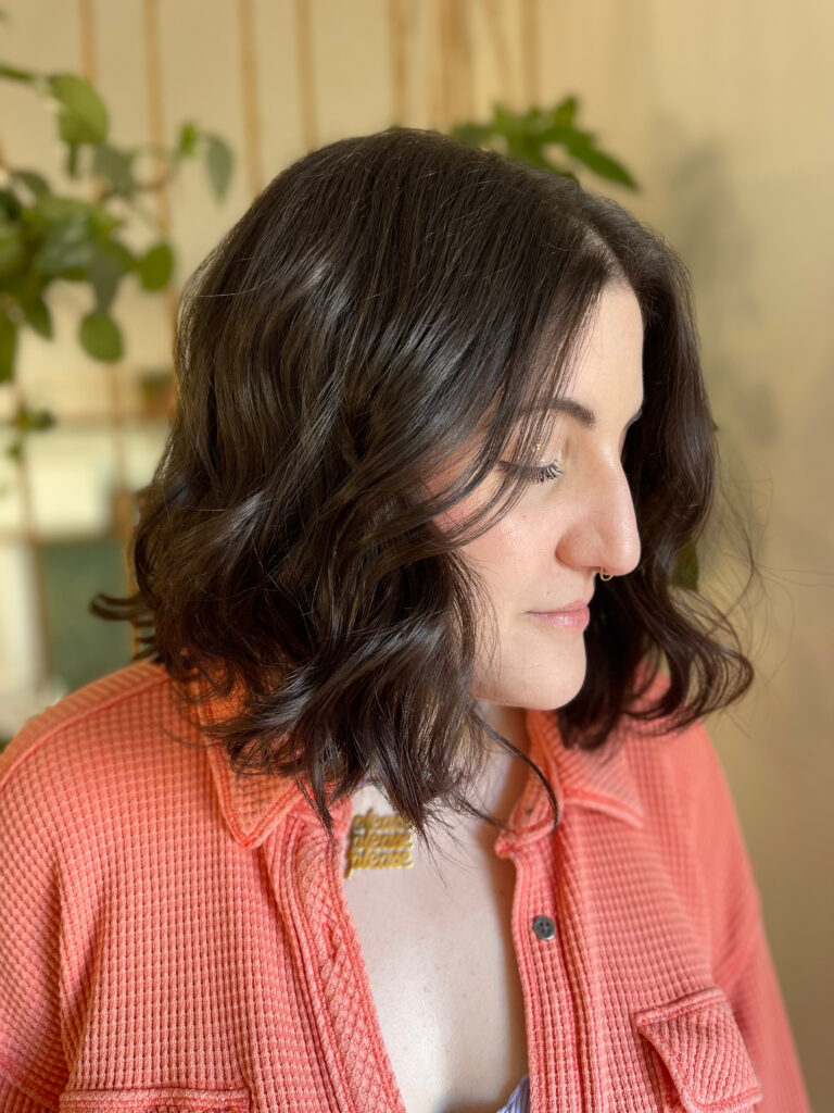 A guest with a glossy dark wavy bob in the BR Collective studio